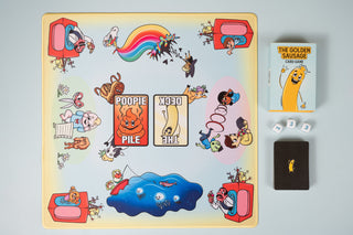 The Golden Sausage Play Mat laid out with cards on the printed deck and Poopie Pile spots
